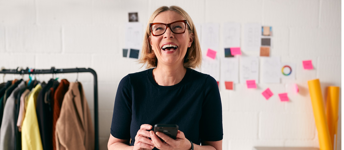 Self employed woman smiling about dental insurance